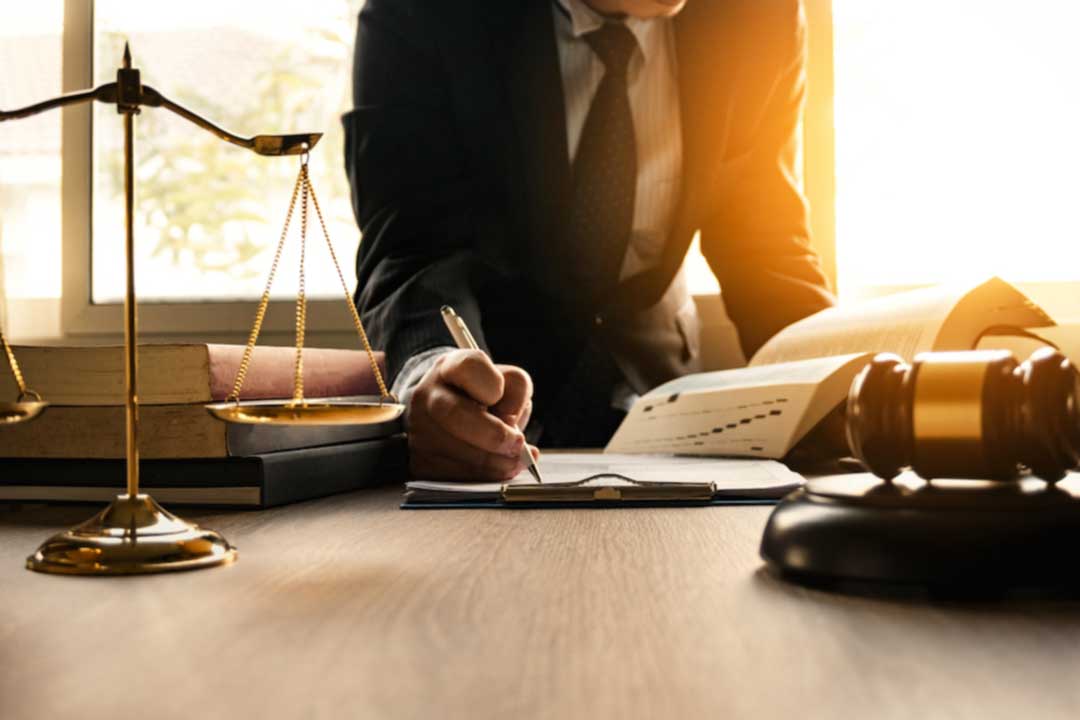 Male lawyer working with contract papers and wooden gavel on tabel in courtroom. justice and law ,attorney, court judge, concept.